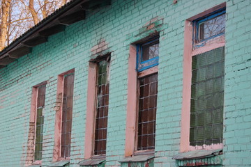 Windows of glass blocks, abandoned house green. destruction of buildings without maintenance