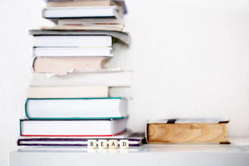 Books on desk and dice with word read as motivation