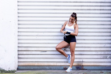 Strong girl in front of garage door with dox gloves prepare for exercise