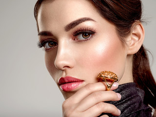 Beautiful young fashion woman with living coral lipstick. Attractive white girl wears luxury...