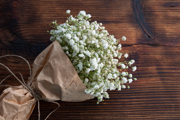 Beautiful bouquet, white flowers on a dark wooden background, rustic style.