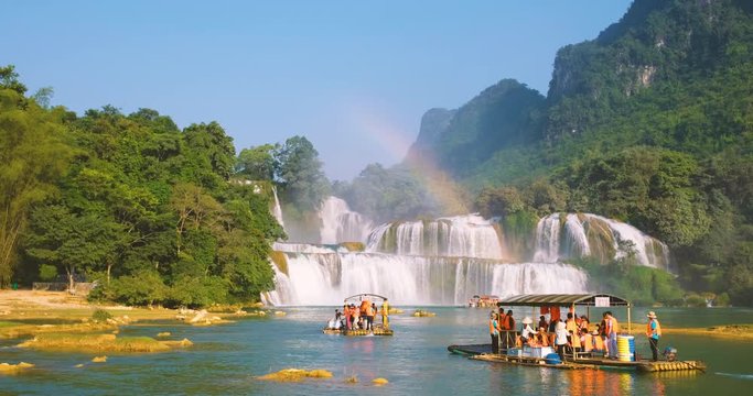 Cao Bang, Vietnam 10 2018: Tourist, traveller, tourism sightseeing waterfall and rainbow on wooden ferry. Ban Gioc waterfall or Detian waterfall is landmark in border Vietnam and Daxin County, China