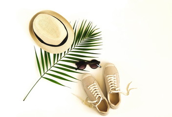 Top view, flat lay fashion women summer travel clothes and accessory collage background. Straw hat, sneakers espadrill, glasses palm leaf. Copy space