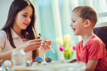 Children painted Easter eggs at the table