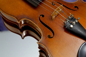 An old and worn out violin on a mirror