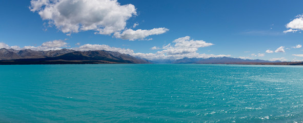 Lake Pukaki on a bright sunny day showing all its turquoise colors