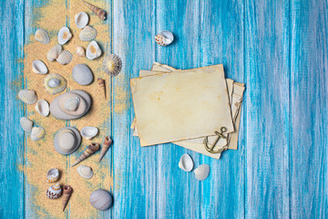 .Concept of summer memories with mockup of vintage photo card and seashells on sand