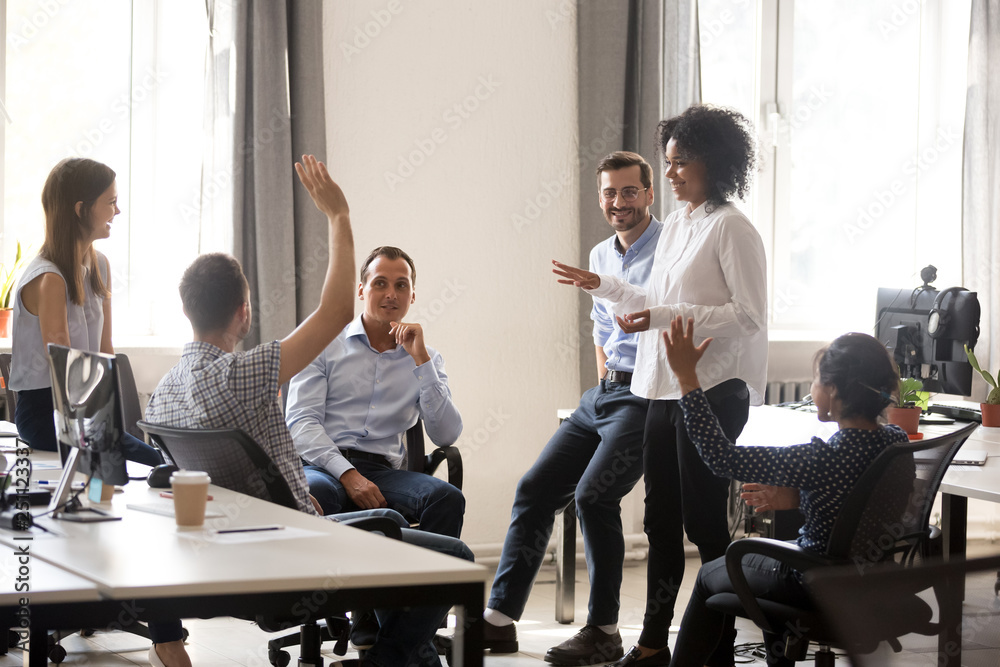 Canvas Prints team leader sharing ideas with colleagues in meeting