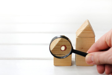 inspection of parts of the house with a magnifying glass in hand. cozy real estate
