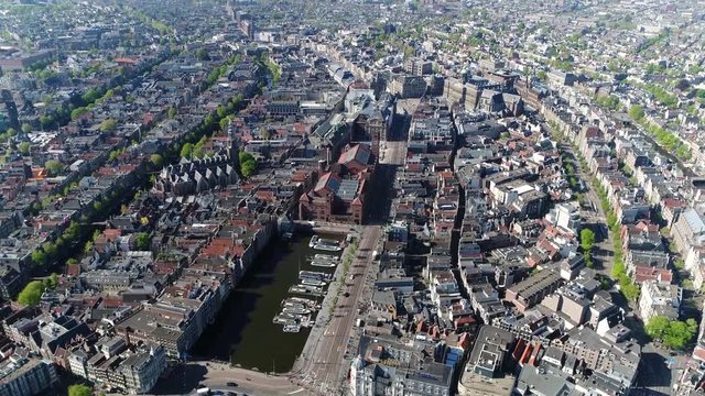 Aerial footage taken from helicopter of Amsterdam city center Damrak is an avenue and partially filled in canal downtown running between the Central railway station and Dam Square 4k high resolution