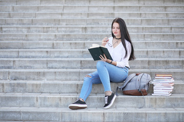 Girl student on the street with books