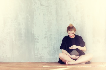 Pregnant young and beautiful girl in a vintage home