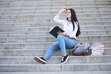 Girl student on the street with books