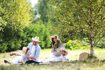 Fototapeta premium Family with children eating watermelon on the nature in campaign.