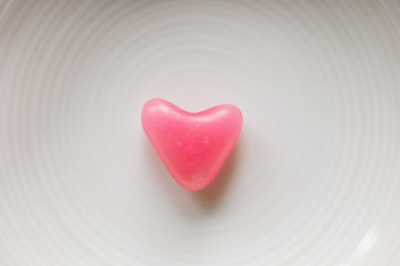 Heart shaped candy on white background. Close up view of red heart candy for design. Love concept.  