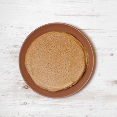 Gluten free pancakes on white wooden background.