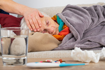 Sick elderly woman on the couch