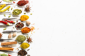 Set of various spices in spoons on white