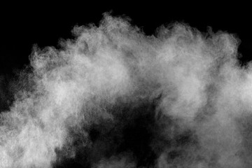 White powder explosion isolated on black background. White dust particles splash.Color Holi Festival.