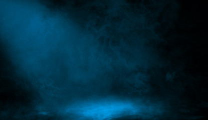 Abstract blue spotlight with smoke mist fog on a black background. Texture background for graphic and web.
