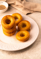 homemade donuts on a white plate, on a grey marble backdrop