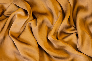 Texture of soft and shiny golden silk