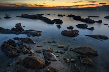 Fototapeta na wymiar The rocks on the sea with sunset sky