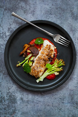 Halibut with hazelnut crust with roast red pepper sauce, asparagus, cauliflower and shiitake mushrooms