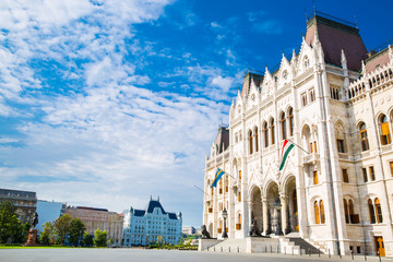 Obraz premium The entrance of Parliament in Budapest, Hungary. Bright summer day with blue sky. 