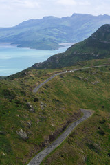 Fototapeta na wymiar Road in mountains with beautiful bay in the background