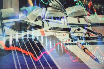 Obraz premium Double exposure of stock market chart and office desktop on background. financial strategy concept.