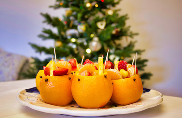 Fototapeta na wymiar stuffed oranges with fruit salad on a christmas table