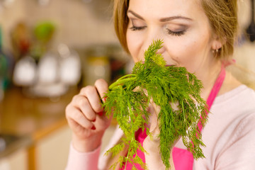 Woman smelling green dill herb