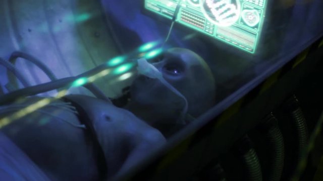 dead humanoid alien lying on the table