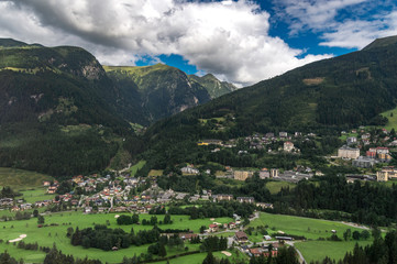 Fototapeta na wymiar Village of the Austrian Alps while traveling by train