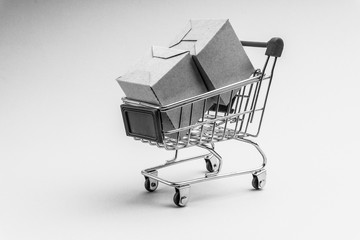 Shopping cart and box  on black and white background, business and shopping concept. Selective focus