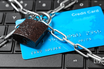 Credit card in chain with lock on laptop keyboard. Ban online payments and purchases in the online store