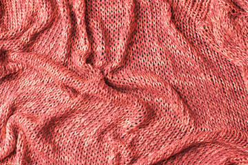 Knitted texture background coral top view flat