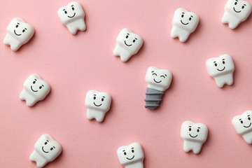 Healthy white teeth and implants are smiling on pink background