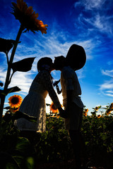 Pareja besándose en campo de girasoles