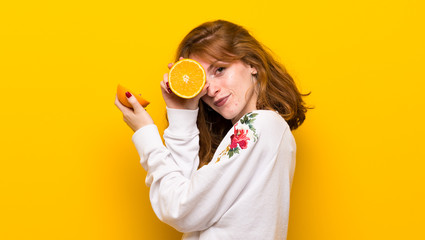 Young redhead woman with orange slices