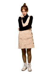 Fototapeta premium A full-length shot of a Young redhead woman looking to the front over isolated white background