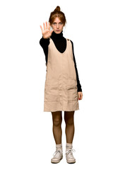A full-length shot of a Young redhead woman making stop gesture denying a situation that thinks...