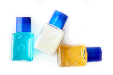 Shampoo and shower gel on a white background. Hotel cosmetic bottles isolated on white. Mini bottle set