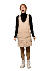 A full-length shot of a Young redhead woman shouting to the front with mouth wide open over isolated white background