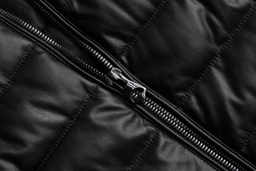 Black leather texture closeup as background. Jacket leather fabric texture.