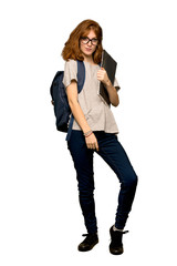 Fototapeta premium A full-length shot of a Young redhead student with glasses and smiling over isolated white background