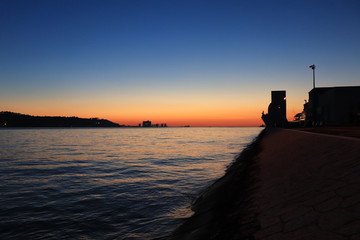 Sunset in Lisbon with the monument of the discoveries in background. Belem in Lisbon, Portugal