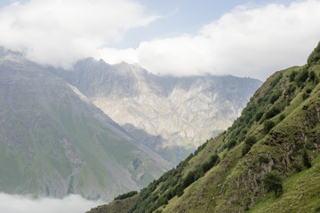 Fototapeta na wymiar Landscape view of the Caucasus Mountains near Trinity Church in Gudauri. Georgia