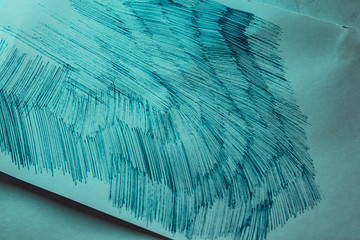 A sheet of white paper with painted dirty strokes, a blue ballpoint pen. Blurred background, shallow depth of field. Drawn record. Incomprehensible scribbles. The texture of an ordinary sheet of torn 